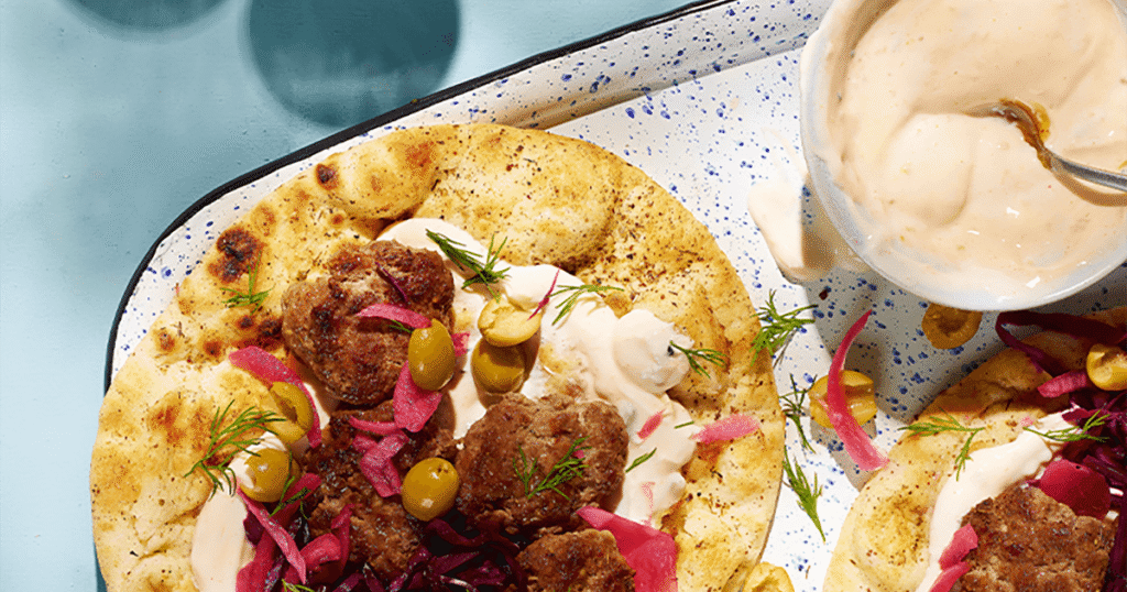 Lamb koftas with mango yoghurt sauce, flatbreads & pickles